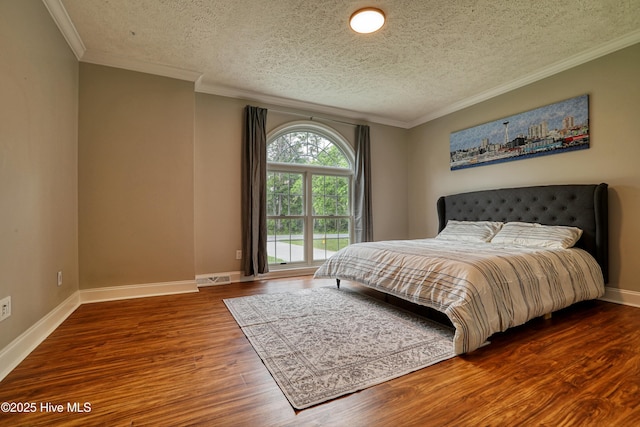 60 Pine Lake Rd, Southport, NC 28461 - bedroom with wood finished floors, a textured ceiling, ornamental molding, and baseboards
