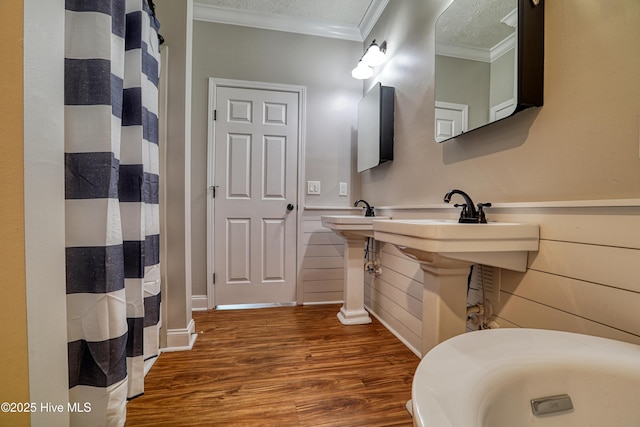 60 Pine Lake Rd, Southport, NC 28461 - bathroom featuring crown molding, wood finished floors, a wainscoted wall, and a shower with shower curtain