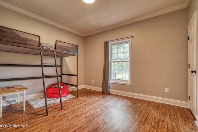 60 Pine Lake Rd, Southport, NC 28461 - bedroom featuring wood finished floors, baseboards, a textured ceiling, and crown molding
