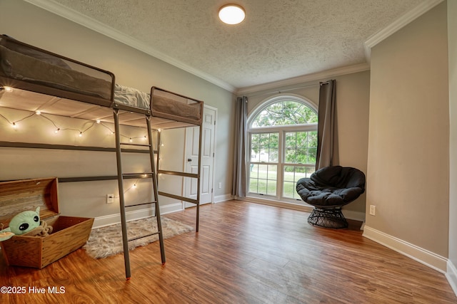 60 Pine Lake Rd, Southport, NC 28461 - bedroom with a textured ceiling, wood finished floors, baseboards, and crown molding