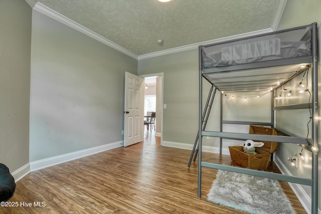 60 Pine Lake Rd, Southport, NC 28461 - unfurnished bedroom with wood finished floors, ornamental molding, a textured ceiling, and baseboards