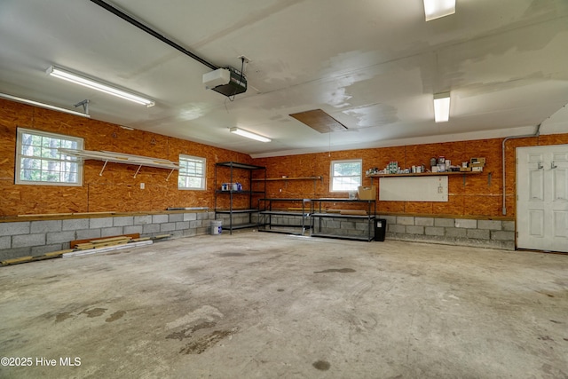 60 Pine Lake Rd, Southport, NC 28461 - garage featuring concrete block wall and a garage door opener