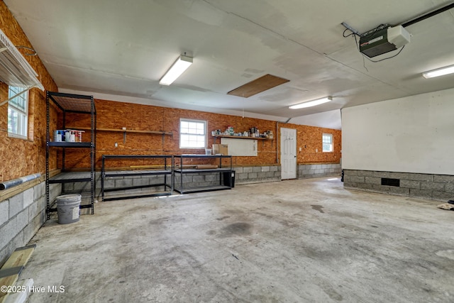 60 Pine Lake Rd, Southport, NC 28461 - garage featuring a garage door opener and a wainscoted wall