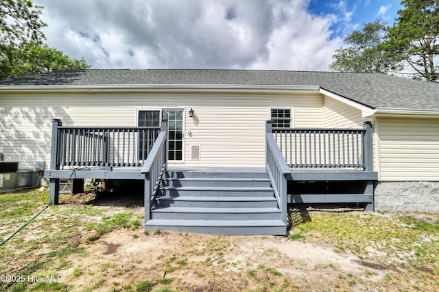 60 Pine Lake Rd, Southport, NC 28461 - back of property with a deck, a shingled roof, and central AC