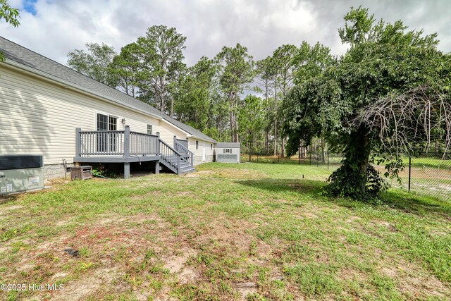 60 Pine Lake Rd, Southport, NC 28461 - view of yard featuring a deck, view of wooded area, and cooling unit