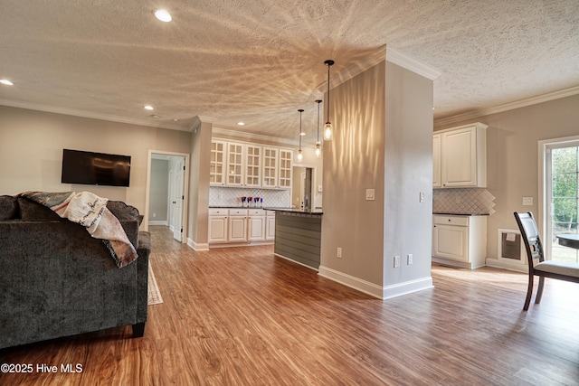 60 Pine Lake Rd, Southport, NC 28461 - living room with wood finished floors, recessed lighting, baseboards, a textured ceiling, and ornamental molding