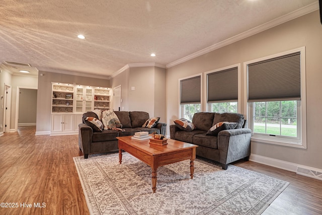 60 Pine Lake Rd, Southport, NC 28461 - living room featuring a textured ceiling, wood finished floors, baseboards, crown molding, and recessed lighting