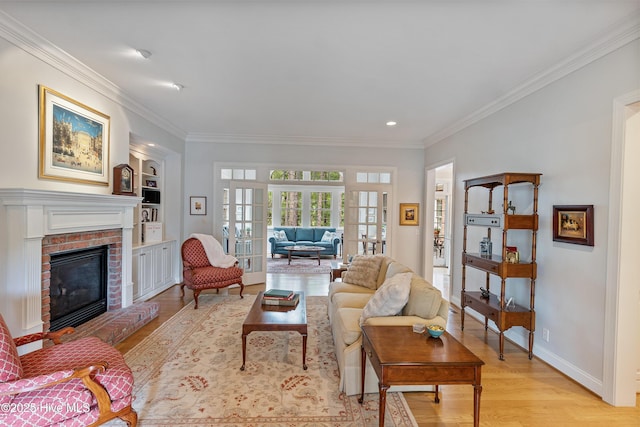 3792 Bancroft Pl, Southport, NC 28461 - living area featuring light wood-style flooring, crown molding, a fireplace, baseboards, and french doors
