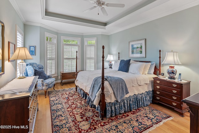 3792 Bancroft Pl, Southport, NC 28461 - bedroom with light wood-type flooring, a raised ceiling, ornamental molding, and ceiling fan