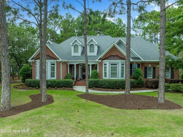 3792 Bancroft Pl, Southport, NC 28461 - view of front facade with brick siding, a front yard, and roof with shingles