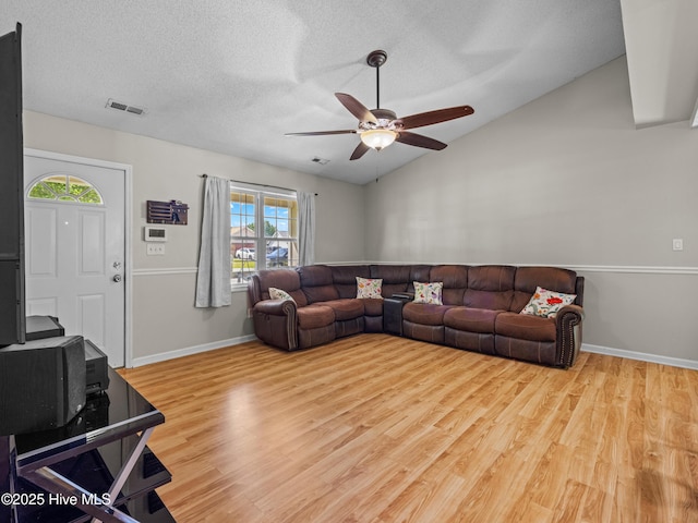 245 Parnell Rd, Hubert, NC 28539 - living area featuring plenty of natural light, ceiling fan, wood finished floors, lofted ceiling, and a textured ceiling