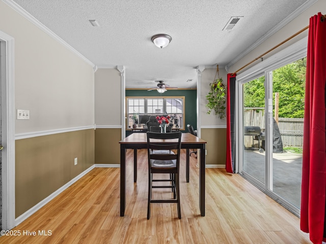 245 Parnell Rd, Hubert, NC 28539 - dining space featuring light wood finished floors, a textured ceiling, a ceiling fan, ornamental molding, and baseboards