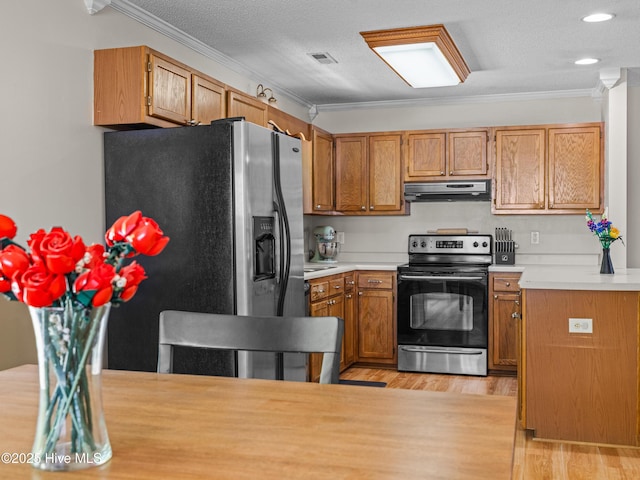 245 Parnell Rd, Hubert, NC 28539 - kitchen with stainless steel appliances, ornamental molding, under cabinet range hood, light wood-style floors, and light countertops