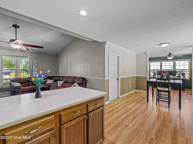 245 Parnell Rd, Hubert, NC 28539 - kitchen featuring open floor plan, ceiling fan, brown cabinets, a textured ceiling, and light countertops