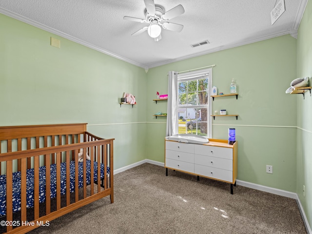 245 Parnell Rd, Hubert, NC 28539 - bedroom with ornamental molding, a textured ceiling, a nursery area, carpet, and baseboards