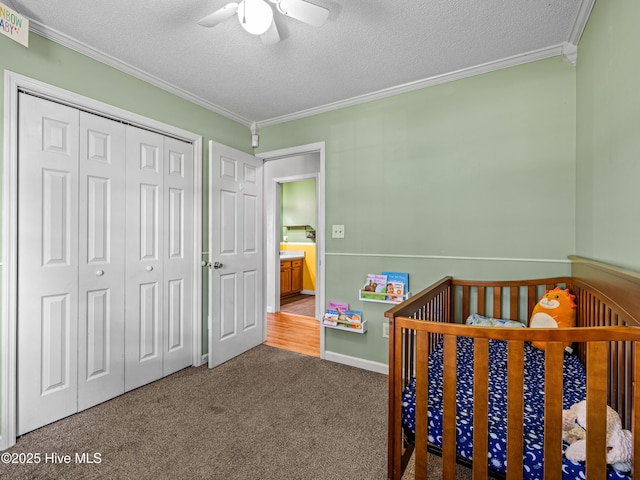 245 Parnell Rd, Hubert, NC 28539 - carpeted bedroom featuring crown molding, a textured ceiling, a closet, a ceiling fan, and a crib