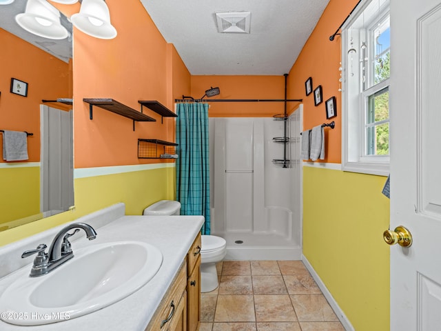 245 Parnell Rd, Hubert, NC 28539 - full bathroom featuring a shower stall, toilet, vanity, a textured ceiling, and baseboards