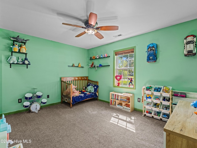 245 Parnell Rd, Hubert, NC 28539 - carpeted bedroom featuring a crib, a ceiling fan, and baseboards