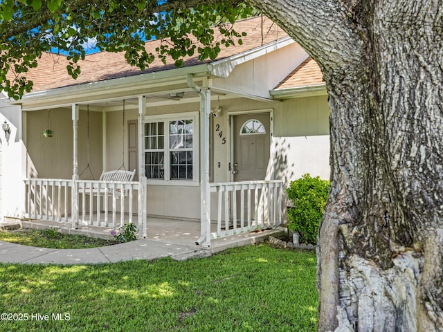 245 Parnell Rd, Hubert, NC 28539 - view of front facade with a porch, a front lawn, and a shingled roof