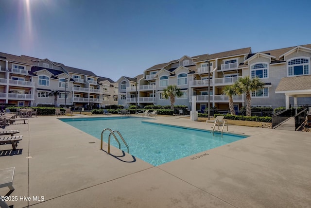 630 Saint Joseph St Unit 200, Carolina Beach, NC 28428 - community pool featuring a patio and a residential view