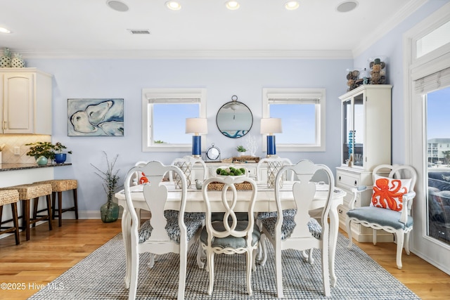 9089 W 9th St, Surf City, NC 28445 - dining space with light wood-style flooring, ornamental molding, and recessed lighting