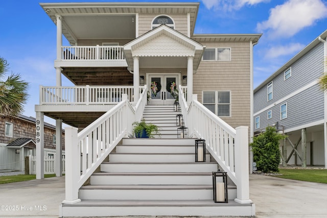9089 W 9th St, Surf City, NC 28445 - coastal home featuring stairway and french doors