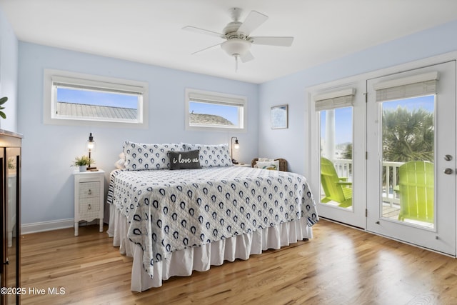 9089 W 9th St, Surf City, NC 28445 - bedroom with access to outside, light wood-style flooring, a ceiling fan, and baseboards