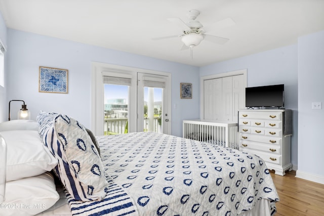 9089 W 9th St, Surf City, NC 28445 - bedroom with access to exterior, light wood finished floors, baseboards, a ceiling fan, and a closet