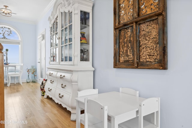 9089 W 9th St, Surf City, NC 28445 - dining space with crown molding, light wood-style floors, and baseboards