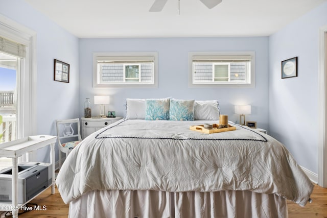 9089 W 9th St, Surf City, NC 28445 - bedroom featuring multiple windows, wood finished floors, and ceiling fan