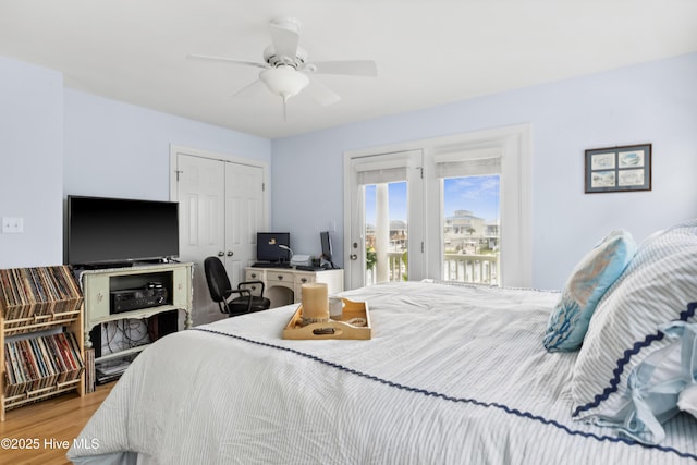 9089 W 9th St, Surf City, NC 28445 - bedroom featuring access to exterior, a closet, wood finished floors, ceiling fan, and a desk