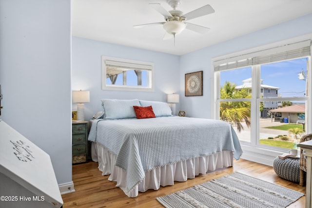 9089 W 9th St, Surf City, NC 28445 - bedroom featuring multiple windows, wood finished floors, ceiling fan, and baseboards