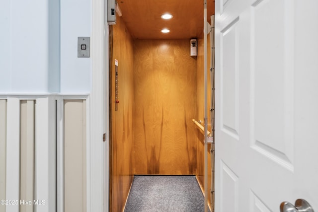 9089 W 9th St, Surf City, NC 28445 - elevator featuring carpet flooring, recessed lighting, and wood walls