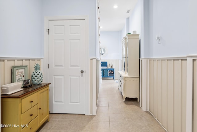 9089 W 9th St, Surf City, NC 28445 - corridor with wainscoting and light tile patterned floors