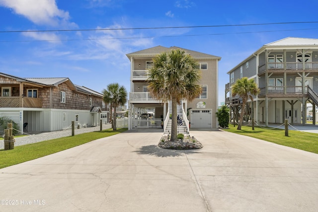 9089 W 9th St, Surf City, NC 28445 - beach home with a carport, a balcony, concrete driveway, a garage, and stairs