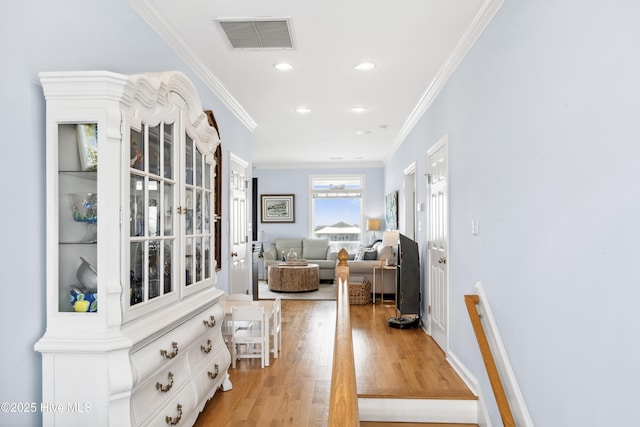 9089 W 9th St, Surf City, NC 28445 - hallway featuring ornamental molding, light wood-style flooring, and recessed lighting