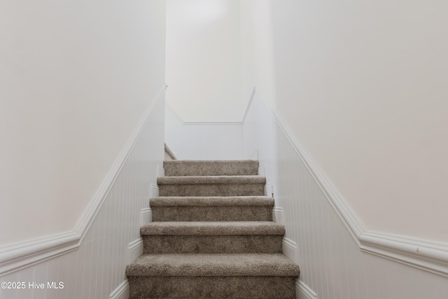 358 Folkstone Rd, Holly Ridge, NC 28445 - stairway featuring a decorative wall and a wainscoted wall