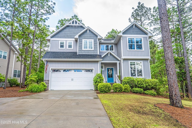 craftsman-style house with driveway, board and batten siding, a garage, and a front lawn