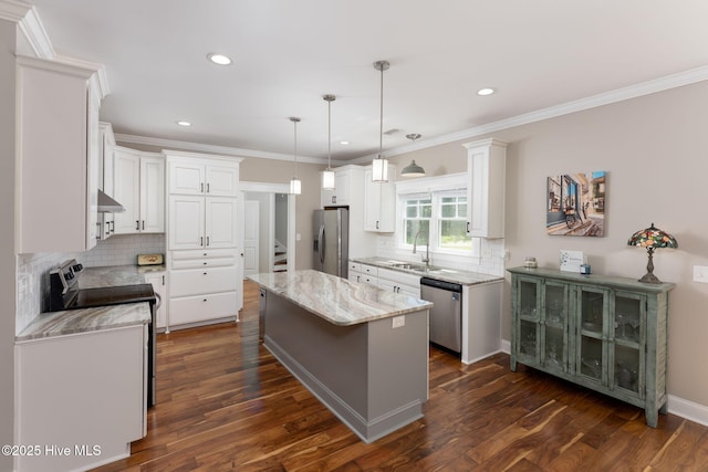244 Red Fox Run Dr, Wallace, NC 28466 - kitchen with appliances with stainless steel finishes, white cabinets, a center island, tasteful backsplash, and dark wood finished floors