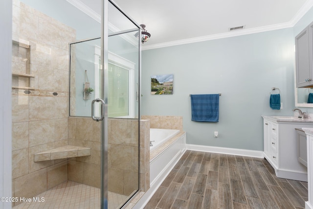 244 Red Fox Run Dr, Wallace, NC 28466 - full bathroom featuring vanity, crown molding, a bath, a shower stall, and wood tiled floors