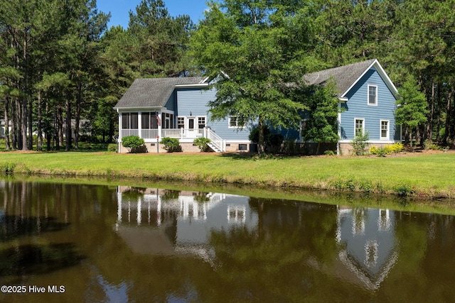 244 Red Fox Run Dr, Wallace, NC 28466 - rear view of house with a water view, a sunroom, and a lawn