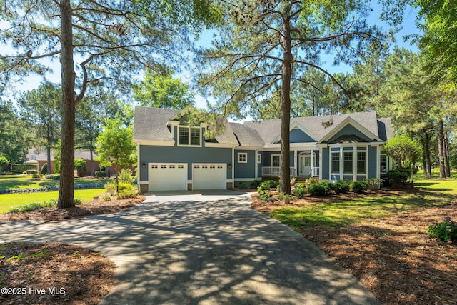 244 Red Fox Run Dr, Wallace, NC 28466 - view of front facade featuring concrete driveway, a garage, a porch, a front lawn, and roof with shingles