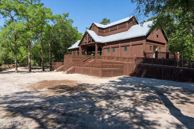 244 Red Fox Run Dr, Wallace, NC 28466 - view of side of property with a deck, stairs, and a metal roof