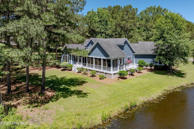 244 Red Fox Run Dr, Wallace, NC 28466 - back of property featuring roof with shingles, a sunroom, crawl space, a lawn, and a water view