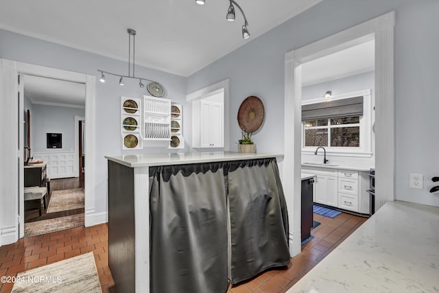 412 S 3rd St, Wilmington, NC 28401 - kitchen featuring a sink, white cabinets, track lighting, light stone countertops, and crown molding