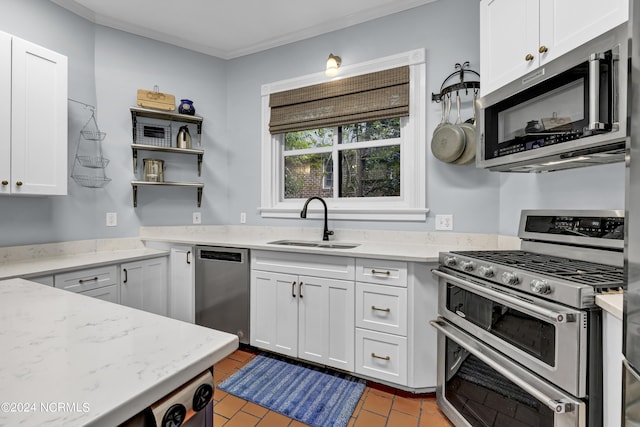 412 S 3rd St, Wilmington, NC 28401 - kitchen featuring stainless steel appliances, a sink, open shelves, white cabinets, and light stone countertops