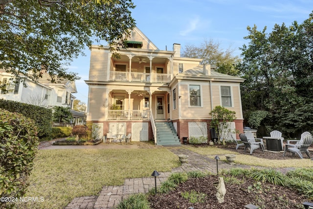 412 S 3rd St, Wilmington, NC 28401 - view of front of house with a balcony, ceiling fan, covered porch, stairs, and a chimney