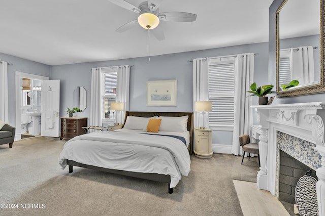 412 S 3rd St, Wilmington, NC 28401 - bedroom featuring light carpet, a fireplace with flush hearth, ceiling fan, and ensuite bath
