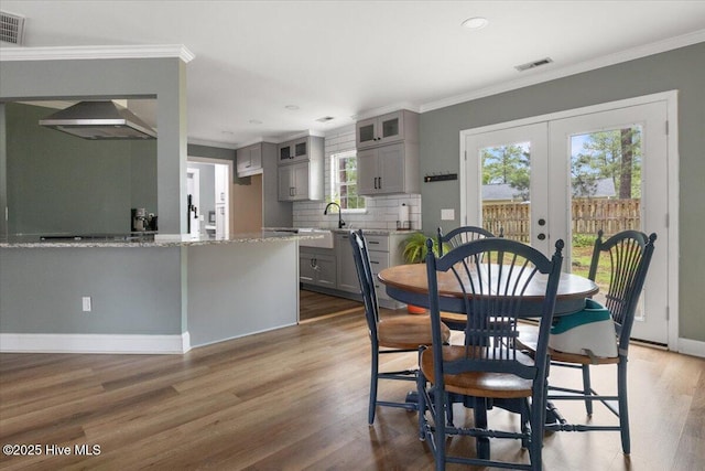 8 Saunders Ln, Pinehurst, NC 28374 - dining room with french doors, wood finished floors, crown molding, recessed lighting, and baseboards