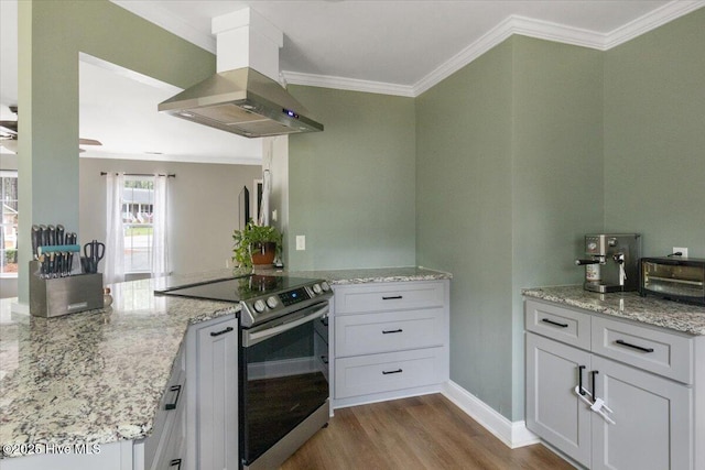 8 Saunders Ln, Pinehurst, NC 28374 - kitchen featuring stainless steel electric range oven, island range hood, crown molding, a peninsula, and dark wood finished floors
